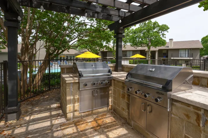 Outdoor grilling station at Oak Park Apartments in Euless, TX, with stainless steel grills