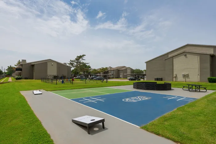Outdoor fitness area at Oak Park Apartments in Euless, TX, with exercise equipment and a spacious layout.