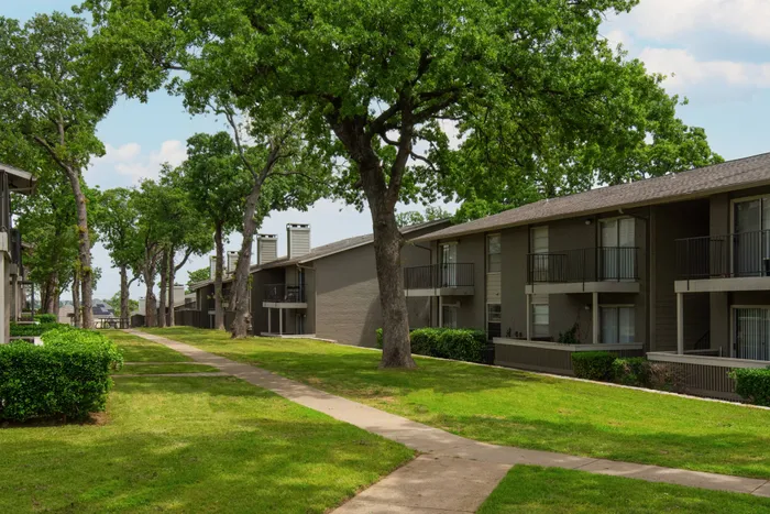 Beautifully landscaped courtyard at Oak Park Apartments in Euless, TX, with pathways and open green spaces.