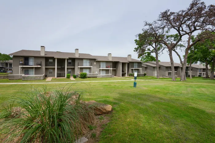 Beautifully landscaped courtyard at Oak Park Apartments in Euless, TX, with pathways and open green spaces.