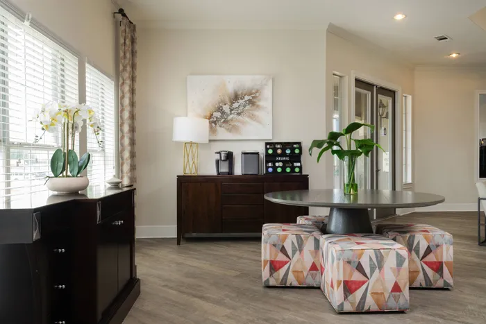 Modern coffee station inside the clubhouse at Oak Park Apartments in Euless, TX, with stylish furniture and decor.