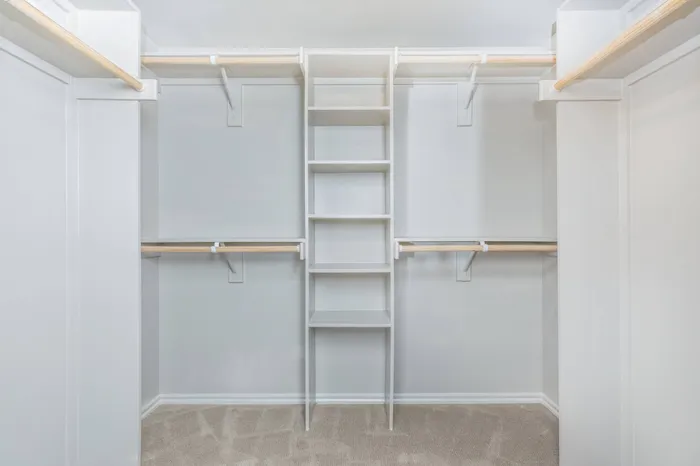 Spacious walk-in closet with built-in shelving and ample hanging space at McDermott 55.