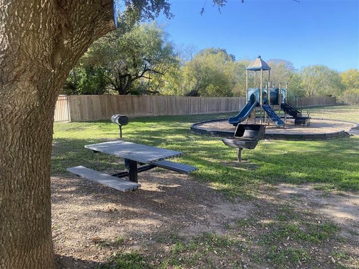 a picnic table next to two on-site grills perfect for your next outdoor barbecue!