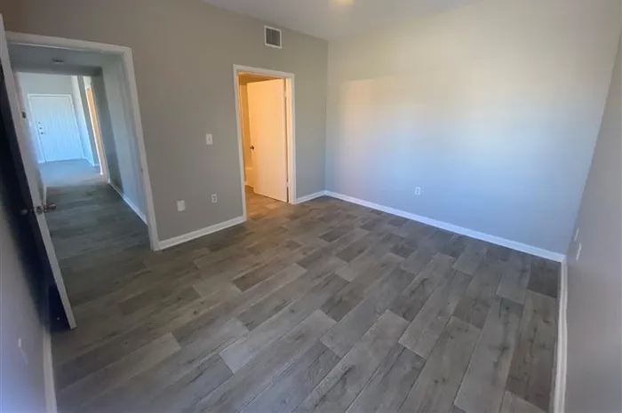 a room with wall-to-wall hardwood vinyl flooring