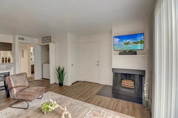 Cozy living room at Oak Park Apartments in Euless, TX, featuring a fireplace, stylish decor, and natural light.