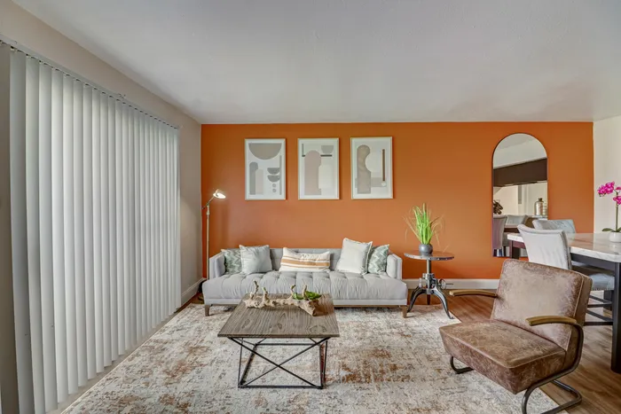 Bright living room at Oak Park Apartments in Euless, TX, with natural light, vibrant decor, and elegant furnishings.