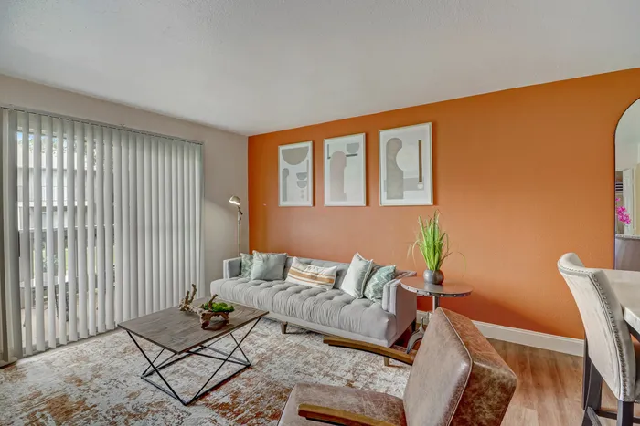 Bright living room at Oak Park Apartments in Euless, TX, with natural light, vibrant decor, and elegant furnishings.