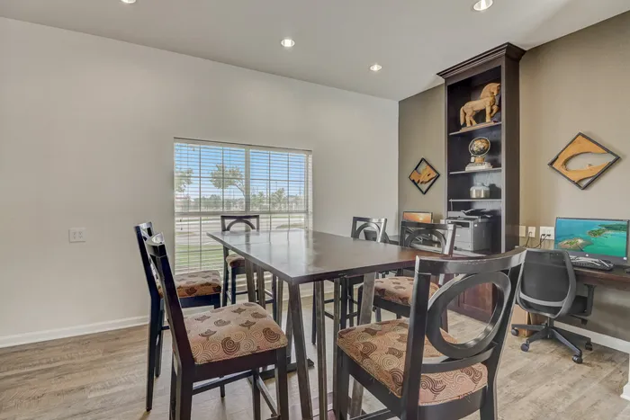 Bright and modern workspace with computers and a large table at Oak Park Apartments in Euless, TX.