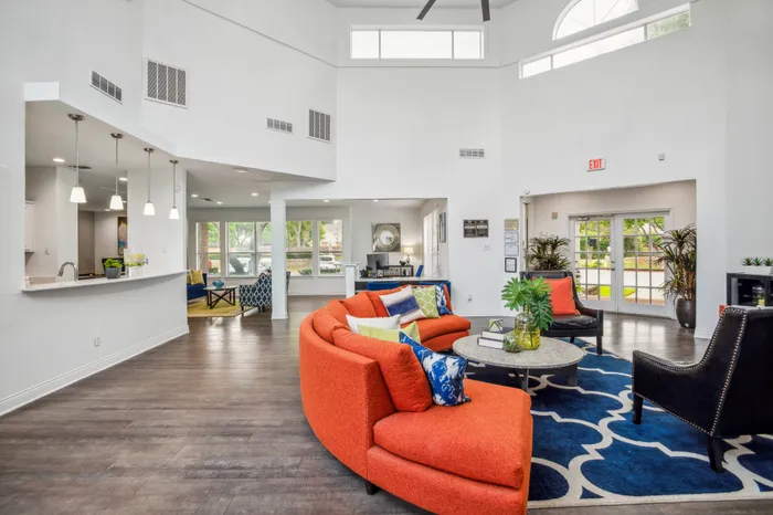 Modern leasing office with bold decor and ample natural lighting in Plano, TX.