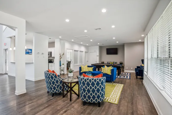 Vibrant community lounge with colorful seating and large windows in Plano, TX.