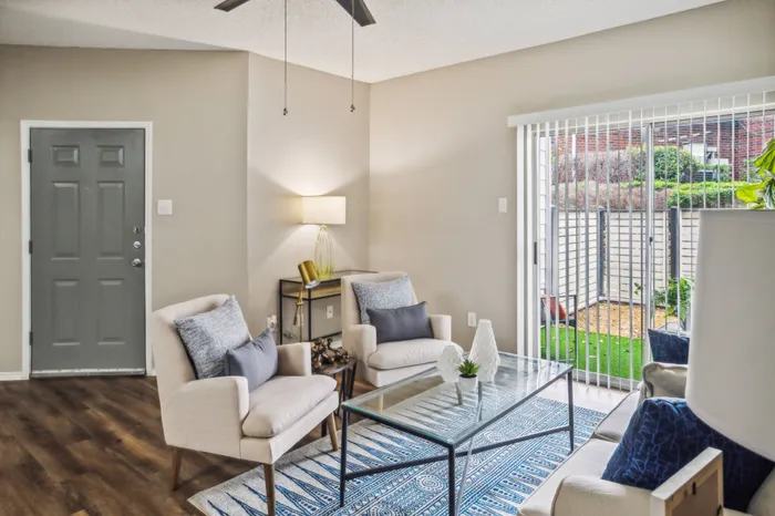 Stylishly furnished living room with wood-style flooring and natural light at a Plano, TX apartment.
