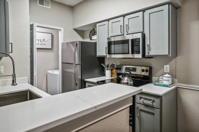 Contemporary kitchen with stainless steel appliances, sleek cabinetry, and a modern design in Plano, TX.
