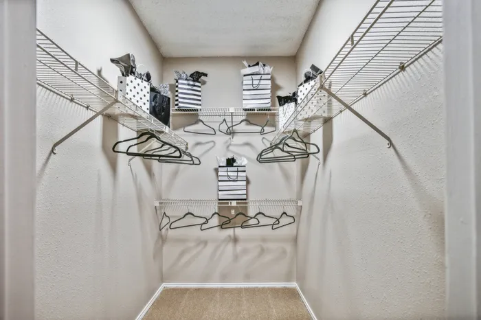 Spacious walk-in closet with organized shelving at a Plano, TX apartment.