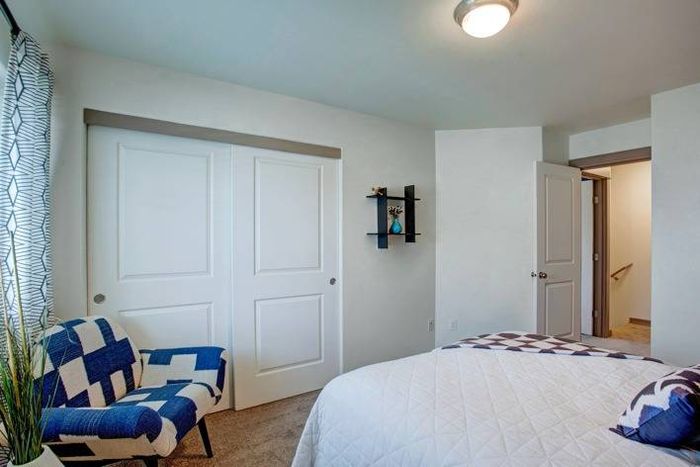 Spacious bedroom with sliding closet doors and modern decor at Navigator Villas in Pasco, WA.
