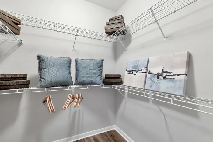 Walk-in closet with wire shelving and organized storage at Amalfi at Tuscan Lakes in League City, TX.