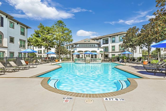 sparkling swimming pool with poolside seating