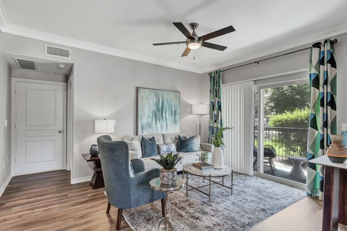 living room with hardwood floors, stunning furniture, and patio access