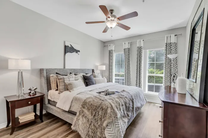room with wall-to-wall hardwood flooring, large windows, and plenty of natural lighting
