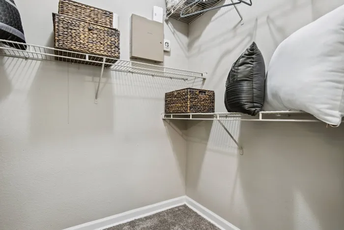 Modern walk-in closet with high-end design features at Katy Ranch, Katy, TX