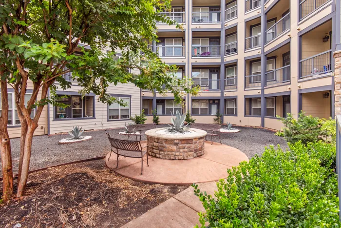 Relaxing outdoor community space with seating by the pool at Katy Ranch Apartments in Katy, TX