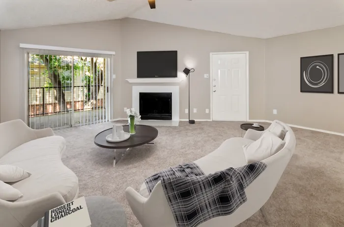 Bright and airy living room with sliding glass doors leading to a private balcony in Plano, TX.