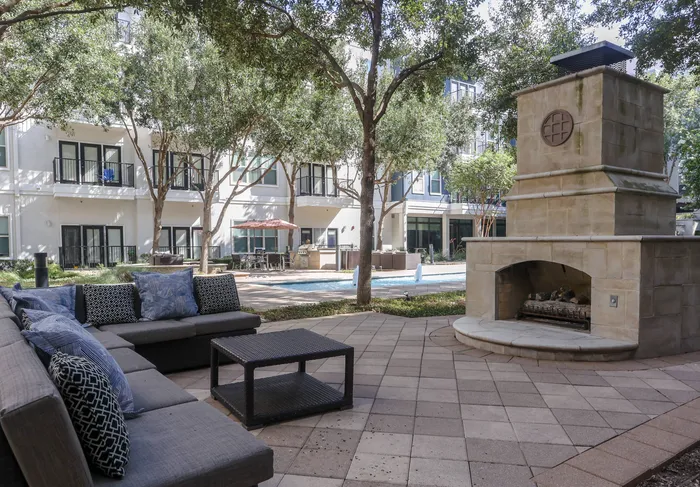 Charming outdoor fireplace with comfortable seating at Addison Keller Springs, Addison, TX