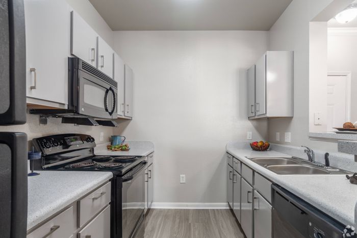 Modern gourmet kitchen with stainless steel appliances at Mansions at Moses Lake, Texas City