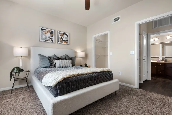spacious bedroom with walkin closet and ceiling fan