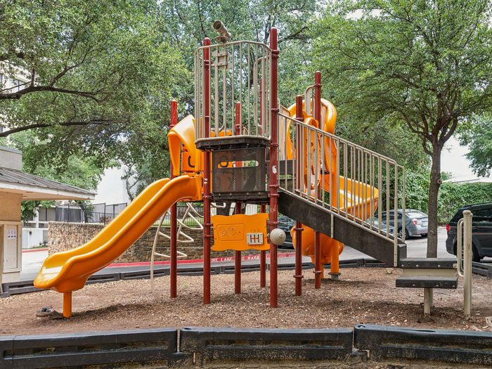 playground with stairs and two yellow slides