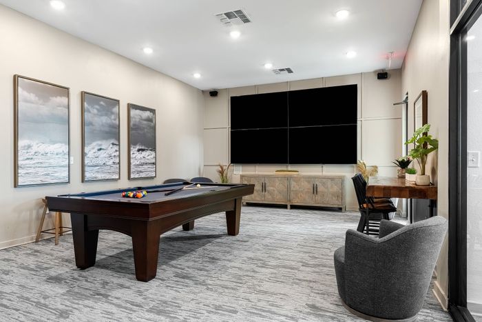 Game room at The Retreat in Corpus Christi featuring pool tables, arcade games, and a relaxing atmosphere.