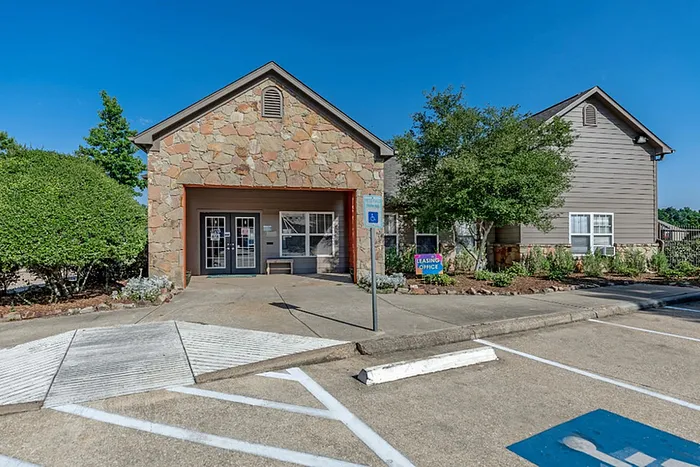a building with a sign that reads "leasing office"