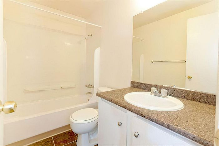 Stylish bathroom with modern fixtures and a spacious vanity at Cottage Bay Apartment Homes in Bremerton, WA