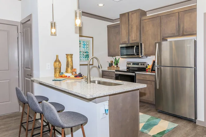 Modern kitchen with granite countertops, stainless steel appliances, and sleek cabinetry at Cityscape Apartments in Houston, TX.