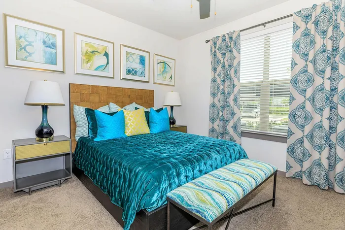 Spacious bedroom with plush bedding, modern decor, and natural lighting at Cityscape Apartments in Houston, TX.