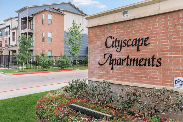 Welcoming property entrance with a landscaped sign for Cityscape Apartments in Houston, TX.