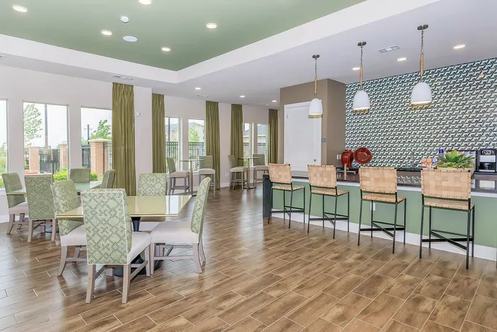 Spacious and elegant resident clubhouse with modern seating, a coffee bar, and large windows at Cityscape Apartments in Houston, TX.