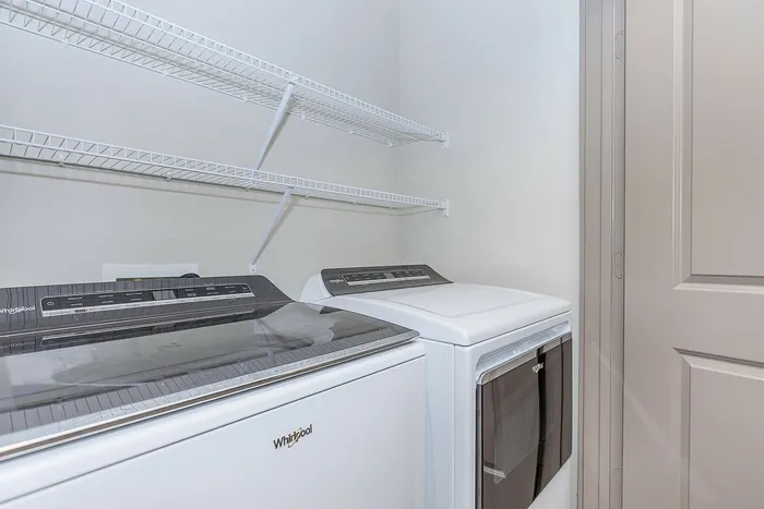 Spacious in-unit laundry area with modern Whirlpool washer and dryer at Cityscape Apartments in Houston, TX.