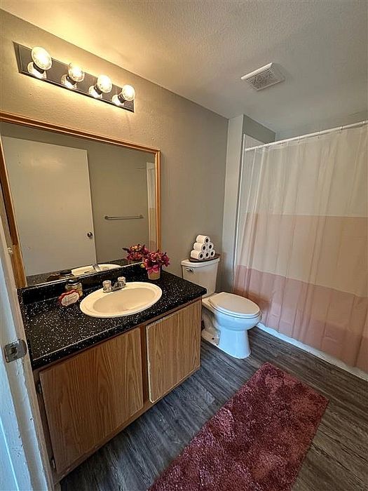 Stylish bathroom with modern fixtures, a large vanity, and a shower-tub combination at Granada Place Apartments in Uvalde, TX.