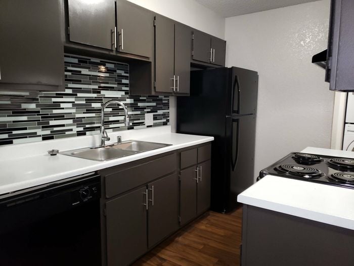 state of the art kitchen with backsplash and black appliances