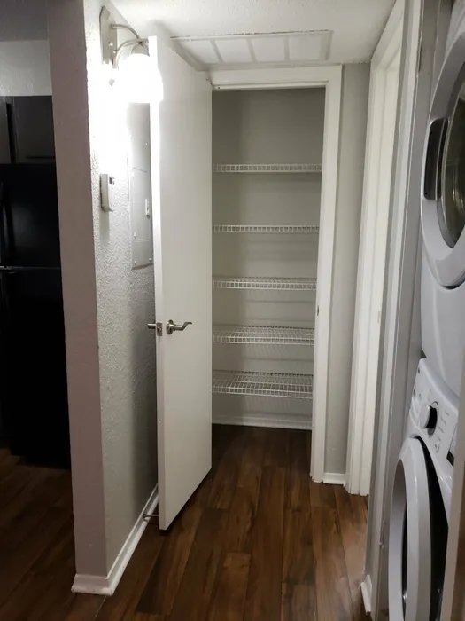 hallway closets and stacked washer dryer