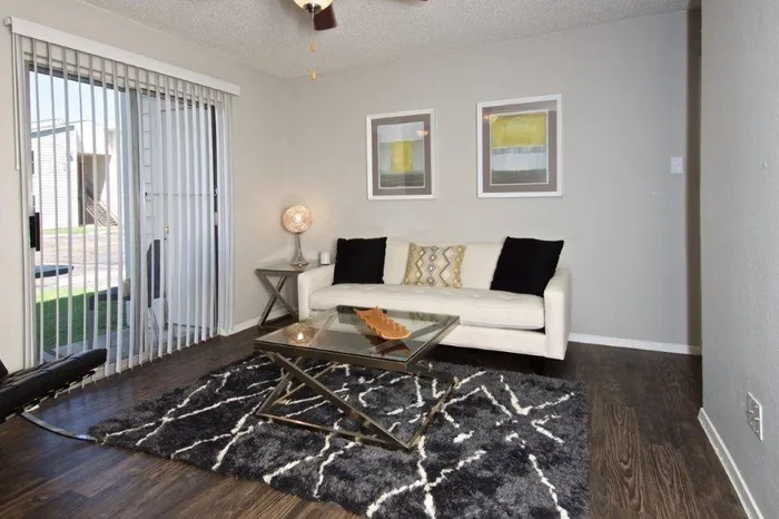 spacious living room with wood style flooring and ceiling fan