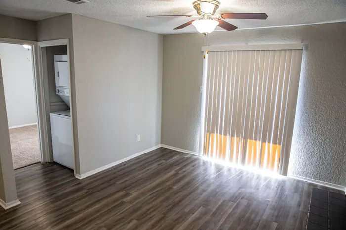 spacious living room with ceiling fan and wood style flooring