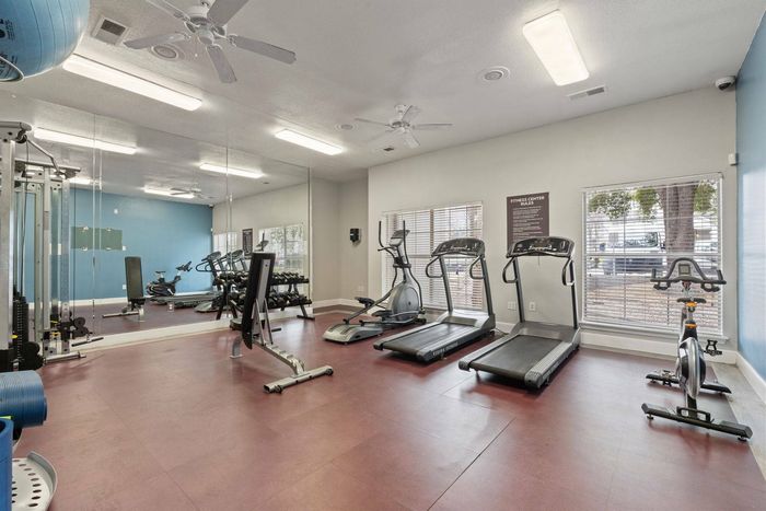 Spacious fitness center with exercise machines and workout space at Avonmora Apartments in Austin, TX.