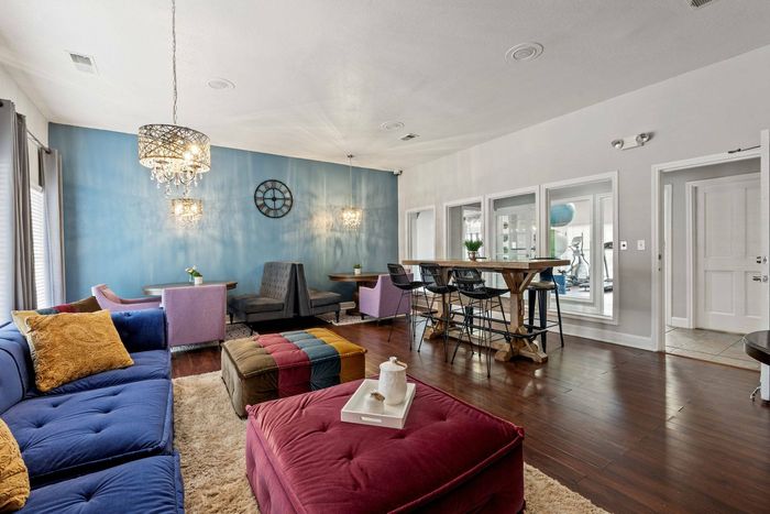 Chic resident lounge with contemporary furniture and vibrant accents at Avonmora Apartments in Austin, TX.