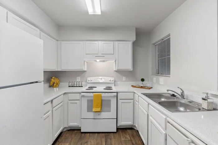 Spacious modern kitchen in Fort Branch at Truman's Landing, Austin, TX with sleek countertops and stainless steel appliances.