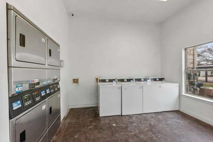 Modern laundry facility at Fort Branch, Truman's Landing, Austin with self-service washers and dryers.