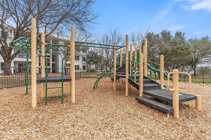 Children playing at the Fort Branch Playground in Truman's Landing, Austin, TX.