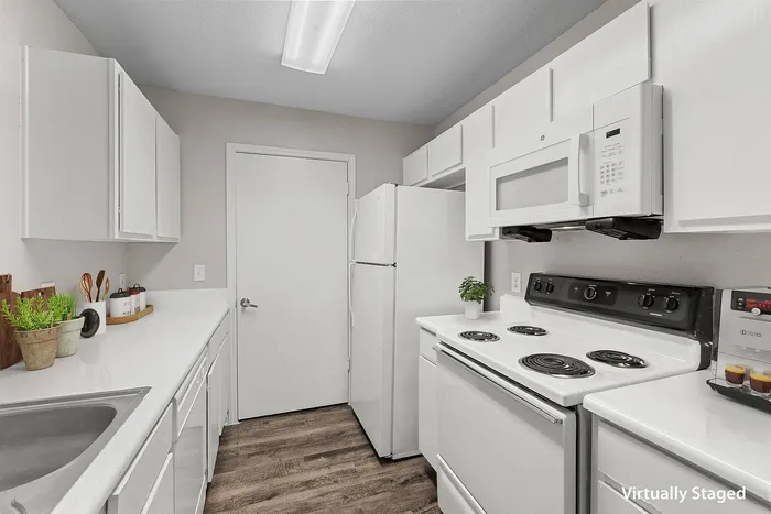 Bright and modern kitchen with stainless steel appliances at Crescent Village Apartments, Elgin, TX