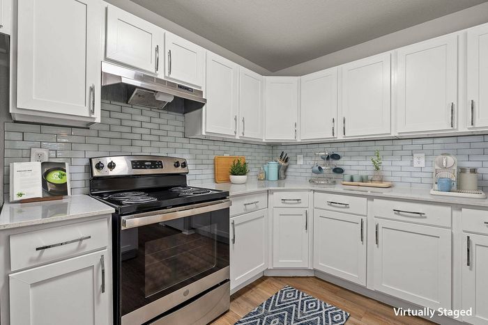 Sleek and modern kitchen in Avonmora Apartments, Austin TX with stainless steel appliances and granite countertops.