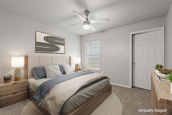 Modern bedroom with desk area and natural light at Avonmora Apartments in Austin, TX.